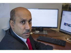 In this Oct. 26, 2018, photo Ali AlAhmed poses for a photograph in his office in Washington. Hackers are impersonating reporters in a bid to intercept the communications of the prominent Saudi opposition figure in Washington. An Associated Press review of malicious emails sent to AlAhmed shows he was approached by hackers masquerading as a BBC reporter and as Washington Post columnist Jamal Khashoggi, who was killed last month at the Saudi consulate in Istanbul. The emails were attempts to break into AlAhmed's inbox. AlAhmed blames the Saudi government for the hacking campaign, although the AP has yet to find any forensic evidence to back that.