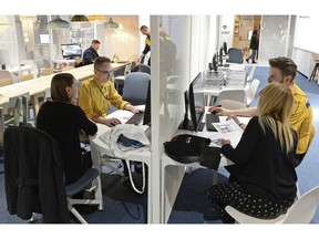 In this Thursday Nov. 22, 2018 photo, Ikea advisors help customers to arrange their interiors, at a new Ikea store, in Warsaw, Poland. The store, recently opened in a city shopping mall, is part of a global strategy by the Swedish furniture chain to adapt to a changing consumer environment by opening small, accessible stores in city centers to complement the traditional large out-of-town store stores.