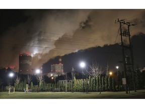 Clouds of smoke over Europe's largest lignite power plant in Belchatow, central Poland, on Wednesday, Nov. 28, 2018. A group of Greenpeace environment activists have climbed its 180-meter smokestack to spur participants in next week's global climate summit in Poland into taking decisions on limiting the use of coal.