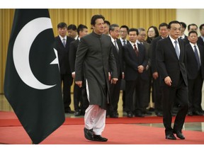 Pakistan's Prime Minister Imran Khan, left, and Chinese Premier Li Keqiang walk together during a welcome ceremony at the Great Hall of the People in Beijing, Saturday, Nov. 3, 2018.