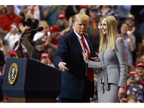 FILE - In this Monday, Nov. 5, 2018, file photo, President Donald Trump greets his daughter Ivanka Trump as she arrives to speak during a rally at the IX Center, in Cleveland. The Chinese government granted 18 trademarks to companies linked to President Donald Trump and his daughter Ivanka Trump over the last two months, Chinese public records show, raising concerns about ongoing conflicts of interest in the White House on the eve of a national election.