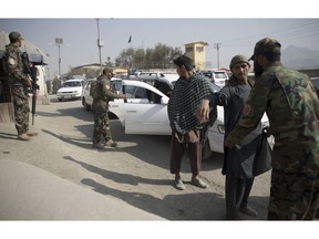 In this Oct. 26, 2018 photo, Afghan National Security Forces search passengers and their vehicles at a checkpoint in Kabul, Afghanistan. Afghans, who once welcomed Americans as liberators, now increasingly see them as the architects of their country's demise. The United States has lost more than 2,400 soldiers in its longest war and spent more than $900 billion on trying to stabilize the country.