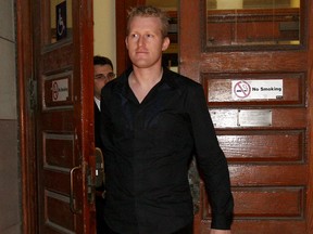 Boaz Manor leaves Old City Hall courthouse in Toronto, on Nov. 13, 2007. Manor received a four-year jail sentence in 2011 for his role in the collapse of the hedge fund Portus Alternative Asset Management Inc.