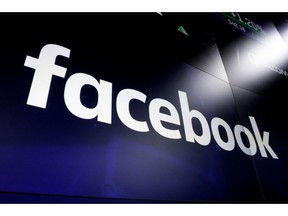 FILE - In this March 29, 2018, file photo, the logo for Facebook appears on screens at the Nasdaq MarketSite in New York's Times Square. A Facebook official says the social media platform is shutting down a series of fake news sites spreading false information about the Bangladesh opposition days before national elections.