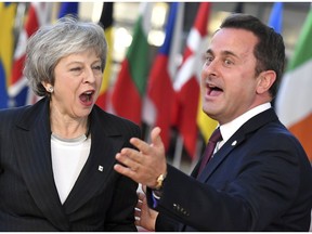 British Prime Minister Theresa May, left, speaks with Luxembourg's Prime Minister Xavier Bettel as she arrives for an EU summit in Brussels, Thursday, Dec. 13, 2018. EU leaders gather for a two-day summit, beginning Thursday, which will center on the Brexit negotiations.