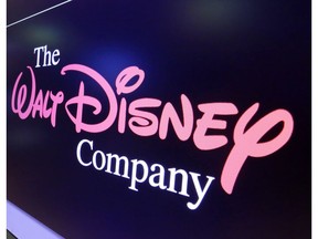 FILE - In this Monday, Aug. 7, 2017, file photo, The Walt Disney Co. logo appears on a screen above the floor of the New York Stock Exchange. A middle-aged male former employee at Disney Cruise Line says in a lawsuit that his younger female manager created a hostile work environment by bullying him about his age, bragging about sexual conquests and passing him over for promotions. Anthony McHugh says in the suit filed in Nov. 2018, that the female manager discriminated against him because of his age and sex.