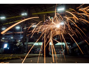 Fabricator Mike Caldarino uses a grinder on a steel stairs being manufactured for a high school in Redmond, Wash., at George Third & Son Steel Fabricators and Erectors, in Burnaby, B.C., on March 29, 2018. Statistics Canada says manufacturing sales fell 0.1 per cent in October to $58.2 billion. The move lower in October came as lower sales in the wood product and primary metal industries were offset by higher sales in the food and machinery industries.
