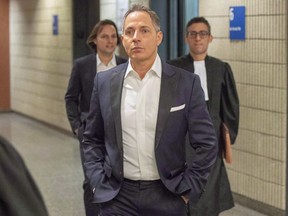 Yanai Elbaz, front, and his brother Yohann Elbaz, left, arrive for their fraud trial at the courthouse in relation to the MUHC hospital in Montreal on Nov. 26, 2018.