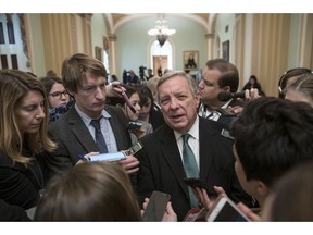 Sen. Dick Durbin, D-Ill., the assistant Democratic leader, is surrounded by reporters asking about the possibility of a partial government shutdown, at the Capitol in Washington, Tuesday, Dec. 18, 2018.