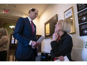 Sen. Ron Wyden, D-Ore., left, and Sen. Patty Murray, D-Ore., wait for Sen. Joe Manchin, D-W.Va., before a news conference to press Congress to intervene on behalf of the Affordable Care Act, after a federal judge in Texas ruled it unconstitutional, on Capitol Hill in Washington, Wednesday, Dec. 19, 2018.
