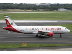 FILE - In this Aug. 16, 2017 file photo an aircraft of  "Air Berlin" with the writing Etihad taxies at the Duesseldorf, western Germany, airport.  A Berlin court said Friday, Dec. 14, 2018 the insolvency administrator for bankrupt airline Air Berlin has sued its former largest shareholder, Gulf airline Etihad, for 2 billion euros (US$2.26 billion) in damages.