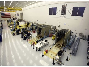 This Sept. 2, 2016 photo provided by Lockheed Martin shows GPS III satellites being built in a clean room at Lockheed Martin's complex south of Denver. The first GPS III satellite is scheduled to be launched from Cape Canaveral, Fla., on Tuesday, Dec. 18, 2018.