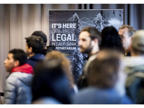 FILE - In this Jan. 6, 2018, file photo, customers line up to buy cannabis at The Apothecarium during the store's first day of recreational marijuana sales in San Francisco. California became America's largest legal marketplace, while Canada became the second and largest country with nationwide legal recreational marijuana.