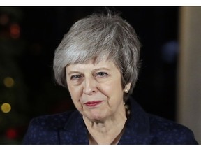 Britain's Prime Minister Theresa May delivers a speech outside 10 Downing Street in London, Wednesday, Dec. 12, 2018. British Prime Minister Theresa May survived a brush with political mortality Wednesday, winning a no-confidence vote of her Conservative lawmakers that would have ended her leadership of party and country.