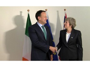 In this framegrab taken from Sky News on Thursday Dec. 13, 2018, Britain's Prime Minister Theresa May shakes hands with Irish Prime Minister Leo Varadkar in Brussels. British Prime Minister Theresa May on Thursday arrived at European Union headquarters in Belgium for crunch Brexit talks with Irish leader Leo Varadkar and EU Council President Donald Tusk. (Sky News via AP)