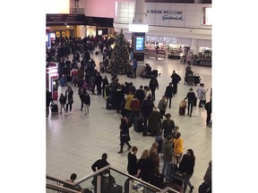 Queues of passengers cross a concourse in Gatwick Airport, as the airport remains closed with incoming flights delayed or diverted to other airports, after drones were spotted over the airfield last night and this morning Thursday Dec. 20, 2018. London's Gatwick Airport remained shut during the busy holiday period Thursday while police and airport officials investigate reports that drones were flying in the area of the airfield.
