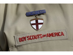 FILE - In this Feb. 4, 2013 file photo, shows a close up detail of a Boy Scout uniform worn during a news conference in front of the Boy Scouts of America headquarters in Irving, Texas.  The Boy Scouts of America says it is exploring "all options" to address serious financial challenges, but is declining to confirm or deny a report that it may seek bankruptcy protection in the face of declining membership and sex-abuse litigation.  "I want to assure you that our daily mission will continue and that there are no imminent actions or immediate decisions expected," Chief Scout Executive Mike Surbaugh said in a statement issued Wednesday, Dec. 12, 2018.