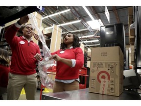 FILE - In this Nov. 16, 2018, file photo, employees demonstrate how air pillow machines work at a packaging station in the backroom of a Target store in Edison, N.J. For many retailers that have lifted pay to attract and keep workers, another challenge has arisen: Making those workers productive enough to justify the larger payouts.