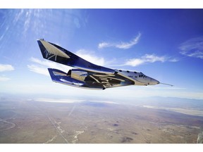 This May 29, 2018 photo provided by Virgin Galactic shows the VSS Unity craft during a supersonic flight test. The spaceship isn't launched from the ground but is carried beneath a special aircraft to an altitude around 50,000 feet (15,240 meters). There, it's released before igniting its rocket engine and climbing. (Virgin Galactic via AP)