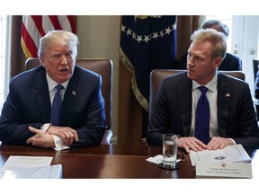 FILE - In this April 9, 2018, file photo, Deputy Secretary of Defense Patrick Shanahan, right, listen as President Donald Trump speaks during a cabinet meeting at the White House, in Washington. A U.S. administration official says that Defense Secretary Jim Mattis will leave his post Jan. 1, 2019, as Trump is expected to name Shanahan as acting secretary.