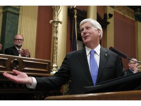 FILE - In this Jan. 23, 2018, file photo, Michigan's Republican Gov. Rick Snyder delivers his final State of the State address at the state Capitol in Lansing, Mich. Snyder signed laws on Friday, Dec. 14, 2018, to significantly scale back citizen-initiated measures to raise Michigan's minimum wage and require paid sick leave for workers, finalizing an unprecedented Republican-backed legislative maneuver that opponents vowed to challenge in court.