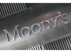 FILE - This August 2010 file photo shows a sign for Moody's Corp. in New York.  Concerns are building from Washington to Wall Street about the trillions of dollars in debt that U.S. businesses have racked up, particularly by companies with relatively weak finances.
