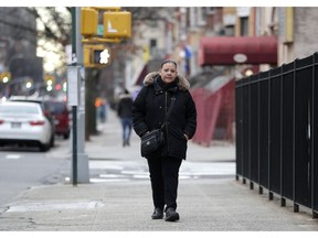 In a photo taken Dec. 23, 2018, Flavia Cabral walks to her mother's home in the Bronx section of New York. Cabral, who works two jobs, will be among many people benefiting from the minimum wage raise which will hit $15 on Dec. 31st.