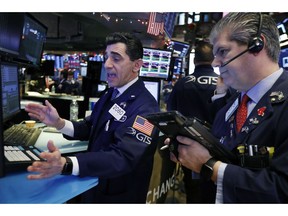 FILE- In this Dec. 6, 2018, file photo specialist Peter Mazza, left, and trader John Panin work on the floor of the New York Stock Exchange. The U.S. stock market opens at 9:30 a.m. EST on Wednesday, Dec. 12.