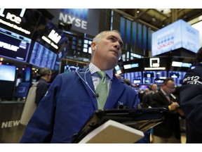 FILE- In this Nov. 29, 2018, file photo trader Timothy Nick works on the floor of the New York Stock Exchange. The U.S. stock market opens at 9:30 a.m. EST on Friday, Dec. 14.