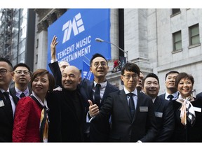 Tao Sang Tong, center, Chairman of Tencent Music Entertainment, joins with members of the company for a photo in front of the New York Stock Exchange prior to the Chinese company's IPO, Wednesday, Dec. 12, 2018.