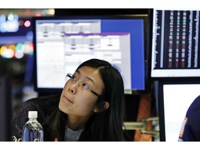 Specialist Vera Liu works on the floor of the New York Stock Exchange, Thursday, Dec. 27, 2018. Wall Street's wild Christmas week goes on, with the Dow Jones Industrial Average slumping 300 points at the open Thursday, a day after notching its biggest-ever point gain.