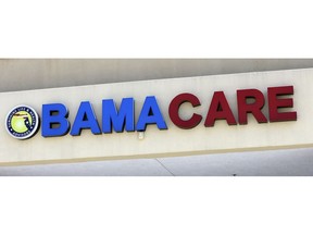 File- This May 11, 2017, file photo shows an Obamacare sign being displayed on the storefront of an insurance agency in Hialeah, Fla. A conservative federal judge in Texas on Friday, Dec. 14, 2018, ruled the Affordable Care Act "invalid" on the eve of the sign-up deadline for next year. But with appeals certain, even the Trump White House said the law will remain in place for now. In a 55-page opinion, U.S. District Judge Reed O'Connor ruled Friday that last year's tax cut bill knocked the constitutional foundation from under "Obamacare" by eliminating a penalty for not having coverage. The rest of the law cannot be separated from that provision and is therefore invalid, he wrote.