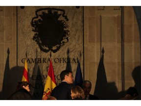 Spain's Prime Minister Pedro Sanchez enters with government ministers for a weekly Cabinet meeting held in Barcelona, Spain, Friday, Dec. 21, 2018. Catalan authorities say pro-independence protesters angry about Spain's Cabinet holding a meeting in Barcelona have blocked a major highway and dozens of roads, disrupting traffic to and from the city.