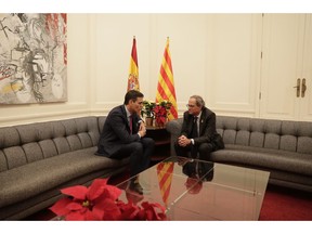 Spain's Prime Minister Pedro Sanchez, left and the president of the country's Catalonia region, Quim Torra talk at the start of a meeting in Barcelona, Spain, Thursday, Dec. 20, 2018. Prime Minister Sanchez met with Catalonia's regional President Torra, who heads a pro-secession coalition and wants self-determination to be part of the talks.