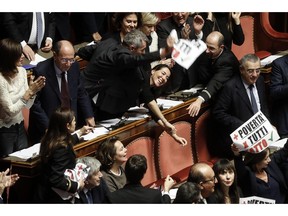 The protest of "Forza Italia" party's senators during the discussion before the vote of confidence on the budget law in the Senate of the Republic, Rome, Italy, Saturday, Dec. 22, 2018.