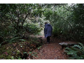 In this Monday, Dec. 10, 2018, photo, Psychologist Hilarie Cash walks on a forest path at a rehab center for adolescents in a rural area outside Redmond, Wash. The complex is part of reSTART Life, a residential program for adolescents and adults who have serious issues with excessive tech use, including video games. Disconnecting from tech and getting outside is part of the rehabilitation process. The organization, which began about a decade ago, also is adding outpatient services due to high demand. Cash is chief clinical officer and a co-founder at reSTART.