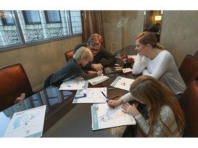 Adam Bryan and Hannah Steadman work with their children Wesley and Greta Rose on puzzles included in complimentary backpacks provided with other incentives by the Wyndham Grand Hotel in Chicago on Dec. 1, 2018. A growing number of hotels are helping guests take a vacation from their vacation by offering incentives to guests willing to lock up their cell phones