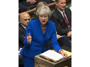 Britain's Prime Minister Theresa May gestures as she speaks during Prime Minister's Questions at the House of Commons in London, Wednesday Dec. 19, 2018. Britain is due to leave the EU on March 29, but it remains unclear whether lawmakers will approve the divorce agreement negotiated with the bloc.