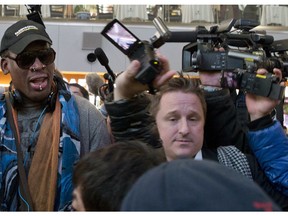 FILE - In this Dec. 19, 2013, file photo, Michael Spavor, center, an entrepreneur, is seen with former NBA star Dennis Rodman, left, on the arrival at the capital airport for a flight to North Korea, in Beijing, China.  A second Canadian man has gone missing in China and is feared detained in what appears to be retaliation for Canada's arrest of a top executive of telecommunications giant Huawei, Canadian authorities said late Wednesday, Dec. 12, 2018.  Canada's Global Affairs department identified its missing citizen as Spavor, an entrepreneur who is one of the only Westerners to have ever met North Korean leader Kim Jong Un. Spavor's disappearance follows China's detention of a former Canadian diplomat in Beijing earlier this week.