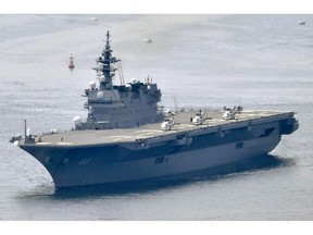 This May, 2017, photo shows Japanese Maritime Self-Defense Force's helicopter carrier Izumo.  Japan has adopted new defense guidelines, calling for converting a destroyer into Japan's first aircraft carrier to deploy advanced U.S.-made stealth fighters, as Japan seeks to increase defense spending and bolster arms capability in coming years. The new national defense plan, approved Tuesday, Dec. 18, 2018, by Prime Minister Shinzo Abe's Cabinet, calls for refitting an existing helicopter carrier into one that can deploy expensive F-35B fighters capable of short take-offs and vertical landings.(Kyodo News via AP)