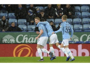 Manchester City's Kevin De Bruyne, left celebrates after scoring the opening goal the game during the English League Cup quarterfinal soccer match at the King Power stadium in Leicester, England, Tuesday, Dec.18, 2018.