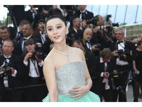FILE - In this May 8, 2018, file photo, Chinese actress Fan Bingbing poses for photographers upon arrival at the opening ceremony of the 71st international film festival, Cannes, southern France. One of China's highest paid celebrities, Fan disappeared from public view for four months before appearing to apologize for tax-evasion. It's not uncommon for individuals who speak out against the government to disappear in China, but the scope of the "disappeared" has expanded since President Xi Jinping came to power in 2013. Not only dissidents and activists, but also high-level officials, Marxists, foreigners and even a movie star, people who never publicly opposed the ruling Communist Party, have been whisked away by police to unknown destinations.