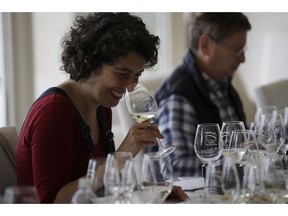 In this image taken on Monday, Oct. 15, 2018, an expert wine tester smiles as she tastes a glass of Prosecco during a wine testing in Asolo, Italy. Prosecco has become the best-selling sparkling wine in the world, and experts say it is eroding the more casual corner of champagne's market while aiming higher. Its production eclipsed champagne's five years ago and is now 75 percent higher at 544,000 bottles three-quarters of which for export.
