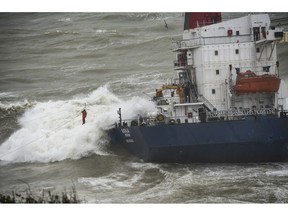 A crew member of a cargo ship that ran aground off the Black Sea coast of Sile, Turkey, is rescued with the help of a winch system extended from the shore, Wednesday, Dec. 19, 2018. Turkish coastal safety teams have rescued 16 crew members from the in a dramatic operation that lasted several hours. The Comoros-flagged ship, Natalia, ran aground in rough seas early on Wednesday en route to Istanbul from Russia.