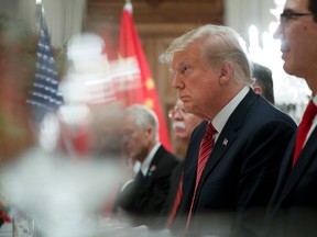 President Trump at the dinner Saturday with Chinese leader Xi Jinping, who is across the table from him. To Trump's left is Steven Mnuchin.