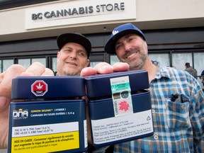 Two customers show off their cannabis purchases outside British Columbia's first legal B.C. cannabis store in Kamloops, B.C. Wednesday, Oct. 17, 2018.