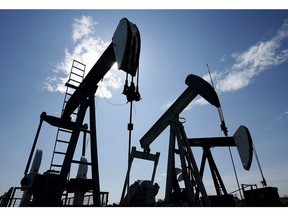 Pumpjacks pump crude oil near Halkirk, Alta., June 20, 2007. A pair of Calgary oil companies are cutting their dividends and reducing production because of current steep discounts on western Canadian oil prices.