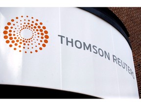 A Thomson Reuters office sign is shown in Boston on August 6, 2009. Thomson Reuters Corp. says it is cutting 12 per cent of its global workforce, or 3,200 full-time jobs, by 2020. The news and information company made the announcement at its annual investor day conference in Toronto.