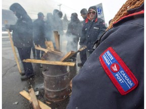 Canada Post workers spend the last hours on the picket line before returning to work after the government ordered them to end their rotating strike Tuesday, November 27, 2018 in Montreal.