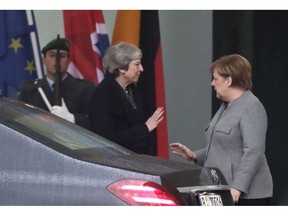 German Chancellor Angela Merkel, right, talks to British Prime Minister Theresa May after a meeting in the chancellery in Berlin, Germany, Tuesday, Dec. 11, 2018. May is visiting several European countries to seek "assurances" on the Brexit agreement with the European Union to aid its passage through Britain's parliament.